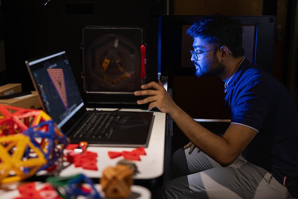 Rupam sits at the computer